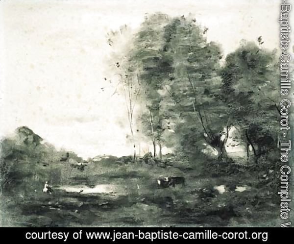 An extensive wooded landscape with cows